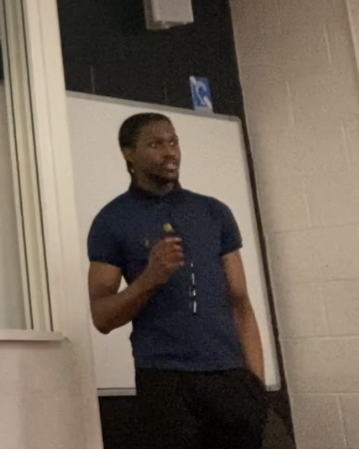 Theo Moore-Calters presenting at a university talk